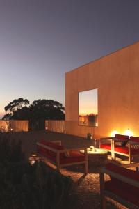 a building with a bench in front of it at Praia do Canal Nature Retreat in Aljezur