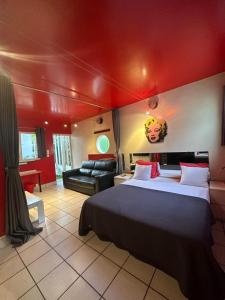 a bedroom with a large bed and a red ceiling at Villaannadakar in Dakar