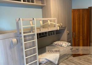 a bunk bed with a ladder in a room at IL NIDO Appartamenti Turistici in Valdobbiadene