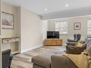 a living room with a couch and a tv at Pass the Keys Newly Renovated 2 Bedroom Town Centre Apartment in Ulverston