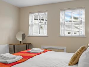 a bedroom with a bed with towels on it at Pass the Keys Newly Renovated 2 Bedroom Town Centre Apartment in Ulverston