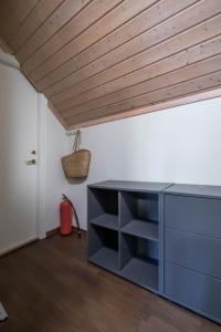 a kitchen with a blue cabinet and a wooden ceiling at Charming and bright apartment in Ålesund city in Ålesund