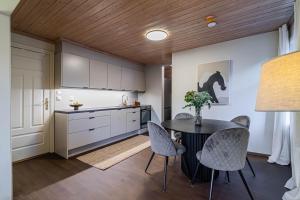eine Küche mit einem Tisch und Stühlen in der Unterkunft Charming and bright apartment in Ålesund city in Ålesund