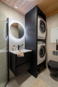 a bathroom with a sink and a washing machine at Charming and bright apartment in Ålesund city in Ålesund