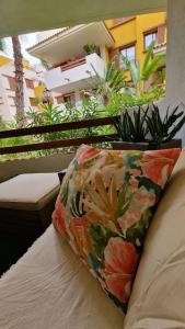 a pillow sitting on a bed on a balcony at Olivia Sunny 2 bedroom Apartament Punta Prima in Torrevieja