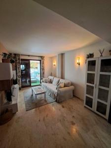a living room with a couch and a table at Olivia Sunny 2 bedroom Apartament Punta Prima in Torrevieja