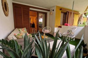 a living room with a couch and some plants at Olivia Sunny 2 bedroom Apartament Punta Prima in Torrevieja