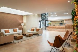 a lobby with couches and chairs and a bar at Sunotel Central in Barcelona