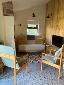 a living room with two chairs and a couch at The Rowe House in Horton in Ribblesdale