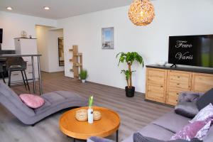 a living room with two couches and a table at FeWo Varis in Röbel