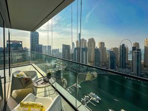 a balcony with a view of a city at HiGuests - High Level Luxury Apartment With Marina Views in Dubai
