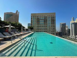 a large swimming pool on the roof of a building at HiGuests - High Level Luxury Apartment With Marina Views in Dubai