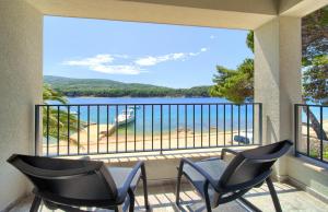 a balcony with chairs and a view of the water at Mamin san in Cres