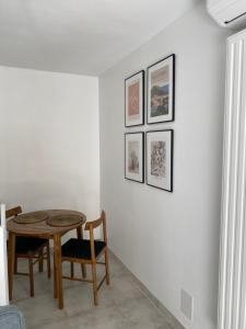 a dining room with a table and three pictures on the wall at Superbe Studio Centre Digne les bains in Digne-les-Bains