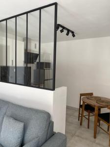 a living room with a couch and a table at Superbe Studio Centre Digne les bains in Digne-les-Bains