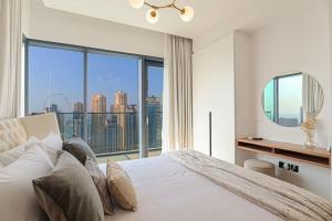 a bedroom with a bed and a large window at HiGuests - High Level Luxury Apartment With Marina Views in Dubai