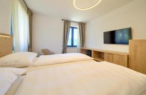 a hotel room with two beds and a flat screen tv at Mamin san in Cres +73 photos