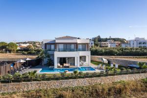 a villa with a swimming pool and a house at Feyre Boutique Mansion in Magnisía