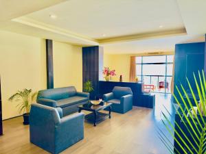 a living room with two blue chairs and a table at Tara Palace Resort and SPA in Gangtok