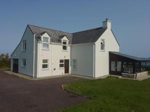 a large white house with a garage at Casey House in Castletownbere