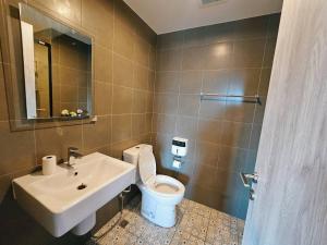 a bathroom with a white toilet and a sink at La Casita Huahin by Ying in Hua Hin