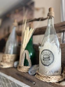 two empty bottles sitting on a wooden shelf at Hotel Anka in Norddorf