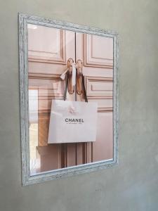 a mirror with a chanel box on a door at Suite Boutique Lodge in Pretoria