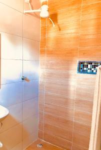 a shower with a glass door in a bathroom at DOM POUSADA in São Gonçalo do Amarante