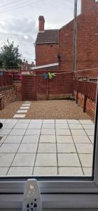 a view from a window of a yard with a fence at Cosy Fresh New Refurbished House in Doncaster