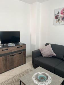 a living room with a couch and a flat screen tv at Leyla in Vodice