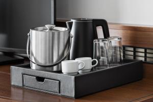 a black tray with a coffee maker and cups on a counter at Courtyard by Marriott Munich City East in Munich