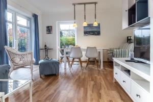 a kitchen and living room with a table and chairs at 50017 Haus Silbermöwe in Harlesiel