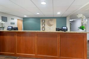a lobby with a reception desk with two computers at Comfort Inn Airport in South Portland