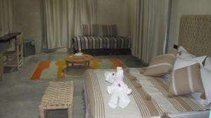 a hotel room with a bed with towels on it at Family Village Marrakech in Marrakech