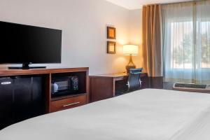 a hotel room with a bed and a flat screen tv at Comfort Inn & Suites Beaver - Interstate 15 North in Beaver
