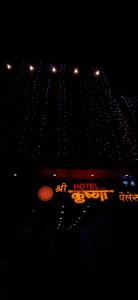 a hotel sign in front of a building at night at Hotel Shri Krishna Palace in Ujjain