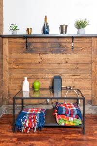 a glass shelf with pillows on it in front of a wooden wall at 1 BR - Parking - Amazing View Nearby! in Pittsburgh