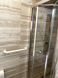 a shower with a glass door in a bathroom at Rabat Pied-a-terre in Rabat