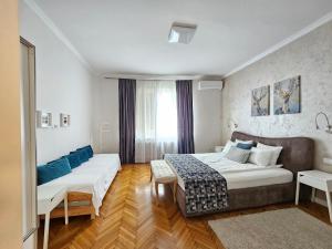 a hotel room with two beds and a couch at Urban Downtown Apartment in Belgrade