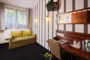 Pokój hotelowy z krzesłem i biurkiem z krzesłem w obiekcie Hotel Beskidzki Raj Medical SPA w mieście Stryszawa