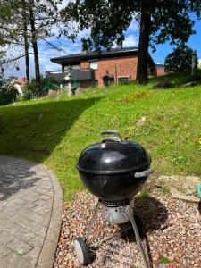 a grill sitting on a stand in a yard at Lugnt och centralt läge in Borås