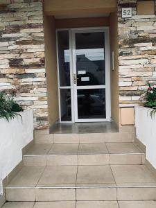 a front door of a house with a stone wall at M. BERNARD in Concordia