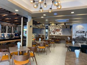 a restaurant with tables and chairs and a counter at The madera lodge pattaya in Jomtien Beach