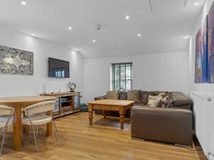 a living room with a couch and a table at Pass the Keys 3 bed Cottage Above Beautiful Country Pub in Baycliff