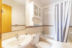 a white bathroom with a sink and a toilet at Can Juan De S'Hereu in Sant Francesc Xavier