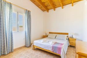 a bedroom with a bed and a window at Can Juan De S'Hereu in Sant Francesc Xavier