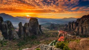 a view of a canyon with tall rocks and a sunset at Veronika house Under Meteora in Sarakína