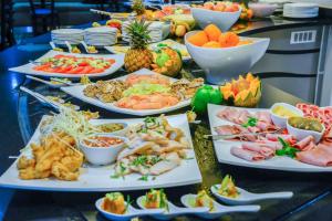 a buffet with many plates of food on a table at Indaba Lodge Hotel Richards Bay in Richards Bay