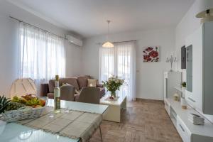 a living room with a couch and a table at Newly renovated apartments in Funtana in Funtana
