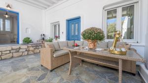 a living room with a table and a couch at Floras Rooms in Pollonia